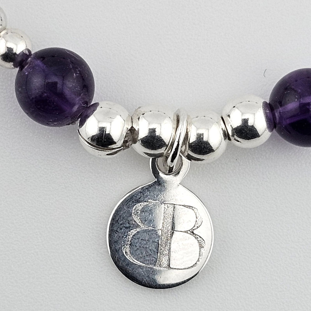 Sterling silver anklet featuring purple amethyst stones.