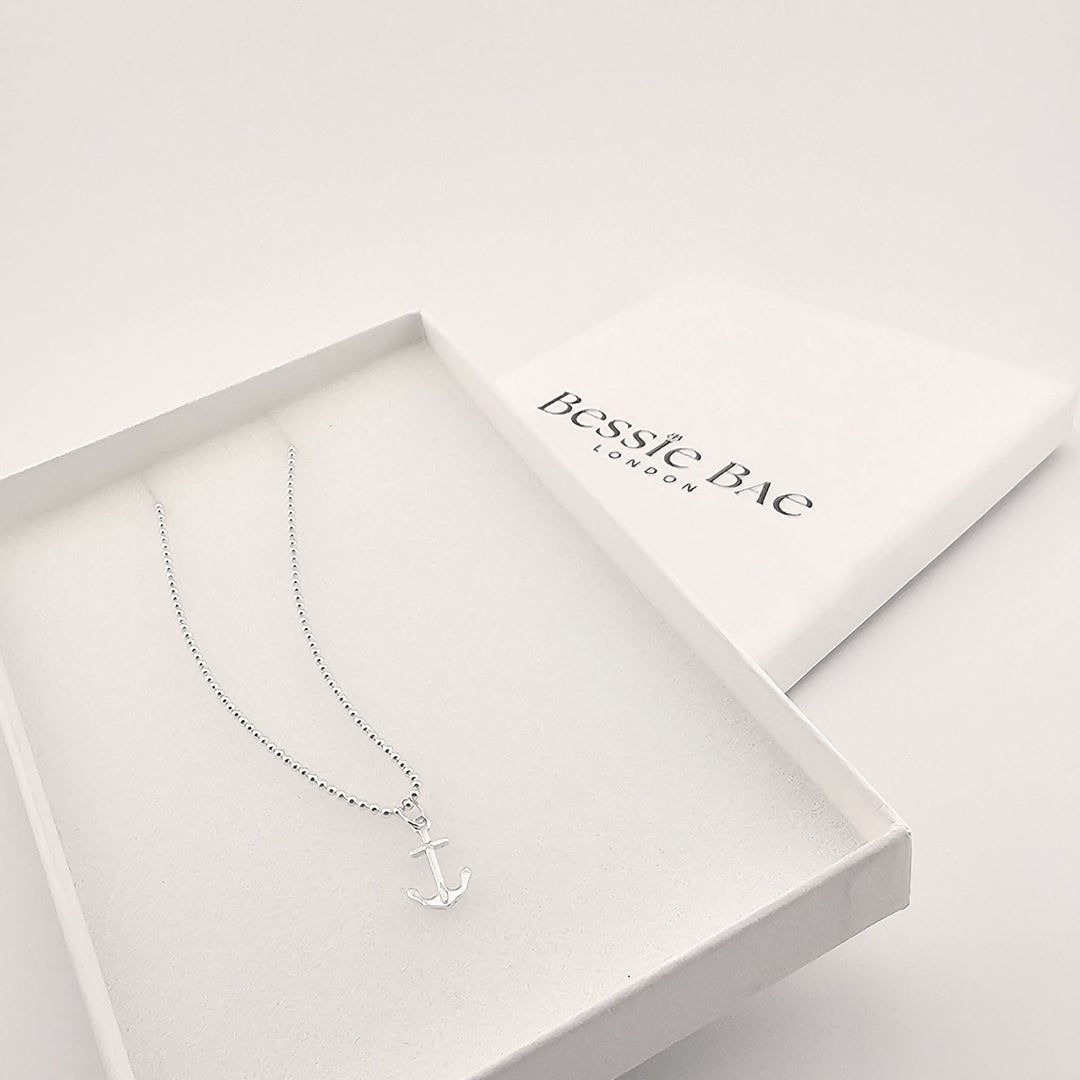 Sterling silver anchor pendant necklace on fine chain in box.