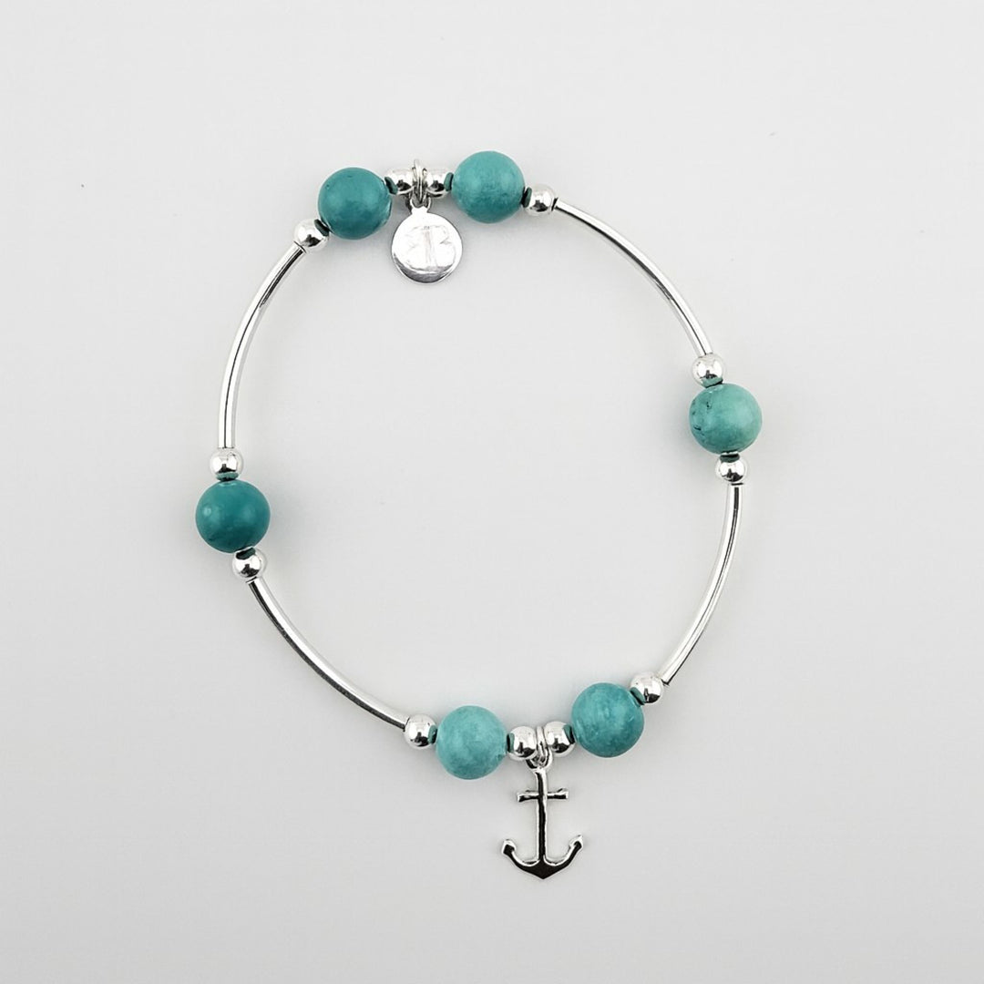 Sterling silver anchor bracelet with turquoise gemstones.