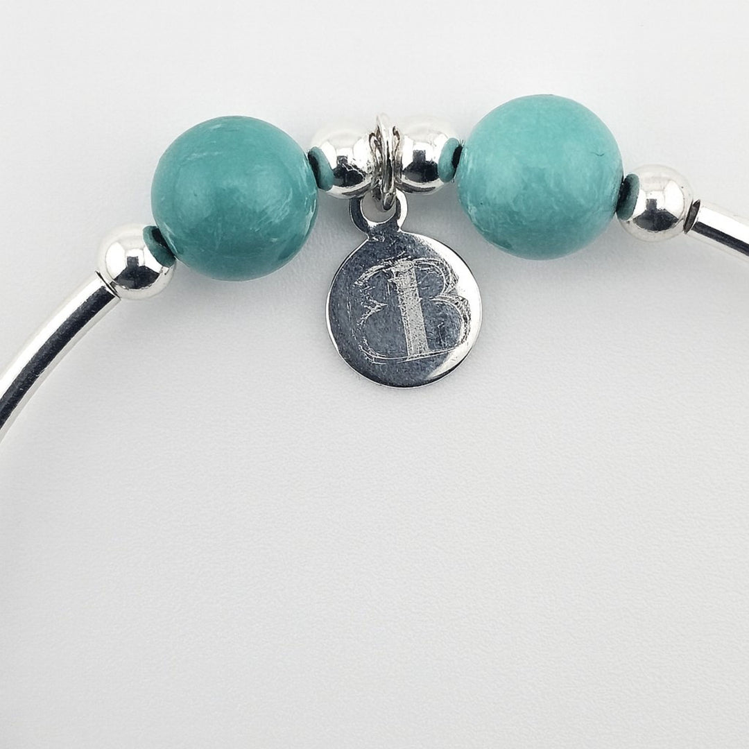 Turquoise gemstone bracelet with sterling silver anchor charm.