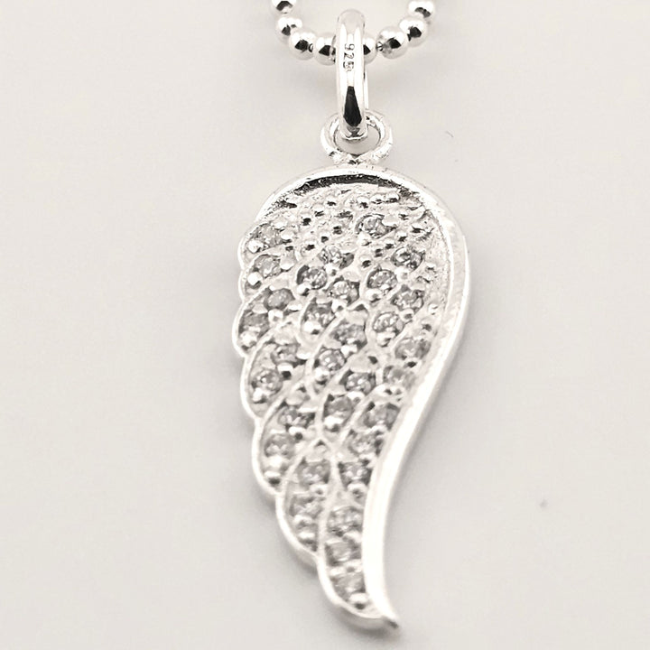 Symbolic sterling silver angel wing necklace for love and protection.