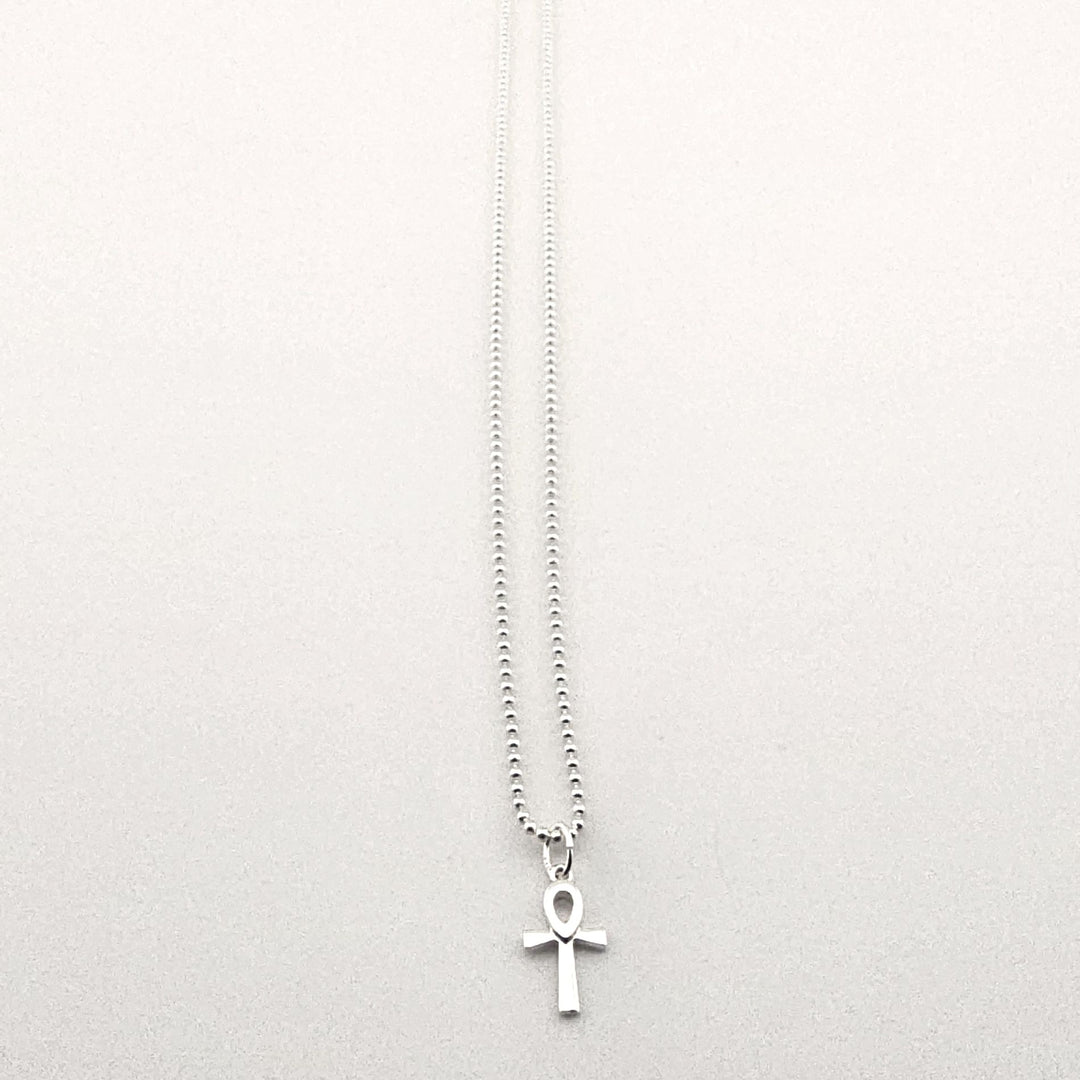 Sterling silver ankh necklace worn as symbolic Egyptian jewellery.
