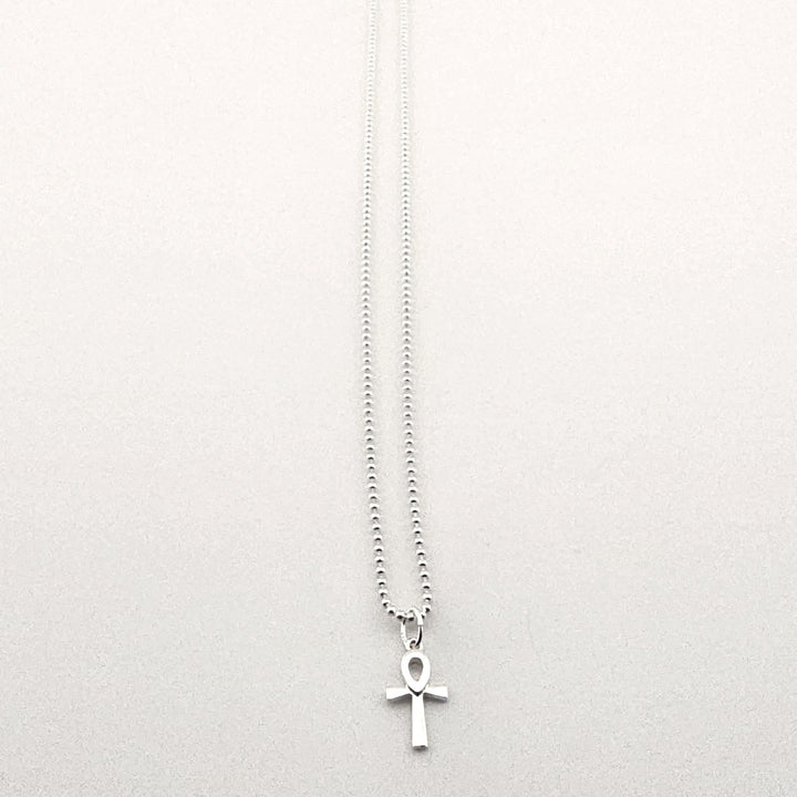 Sterling silver ankh necklace worn as symbolic Egyptian jewellery.