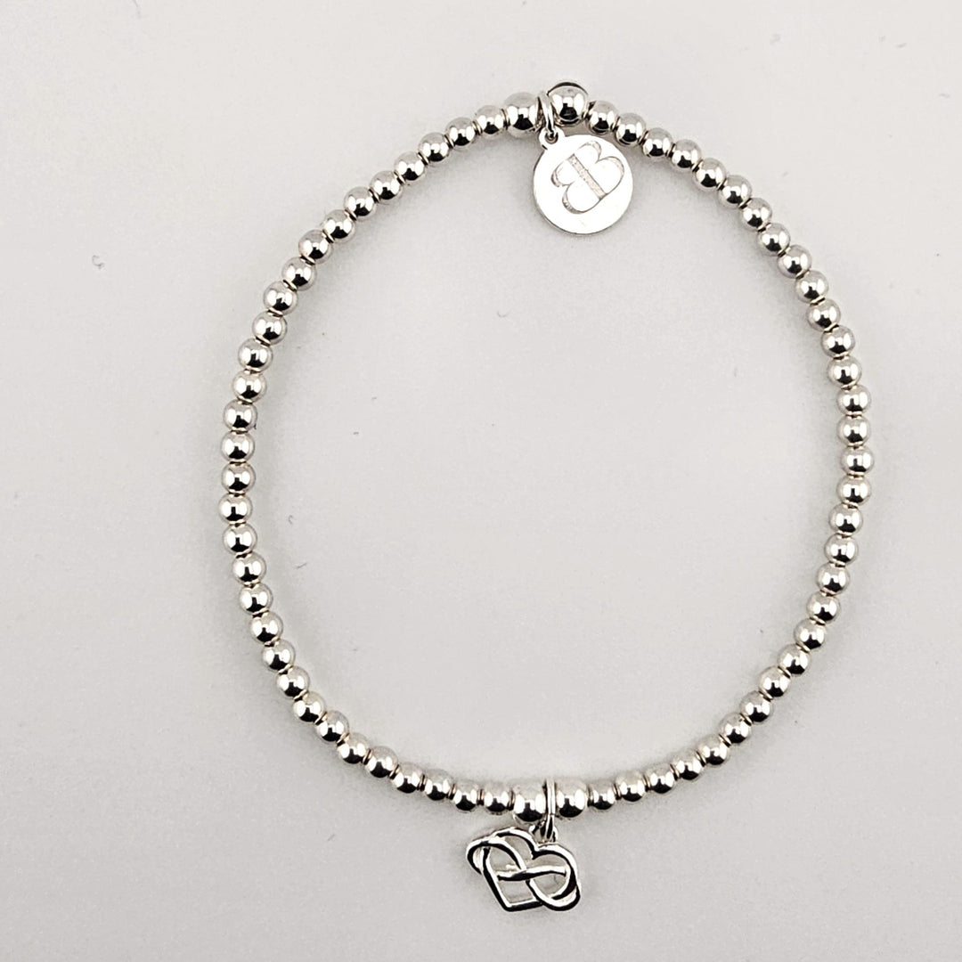Sterling silver beaded bracelet with infinity heart charm.
