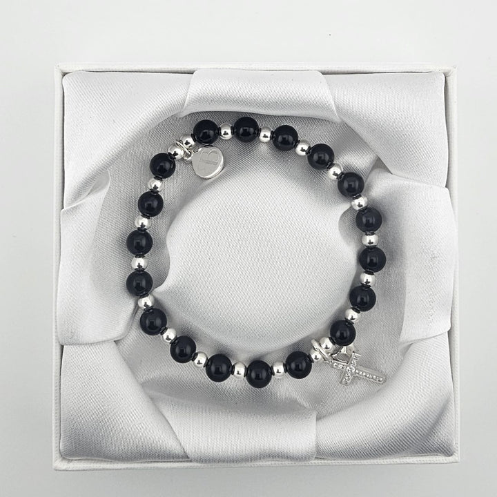 Handmade sterling silver and black onyx bracelet with cross charm.