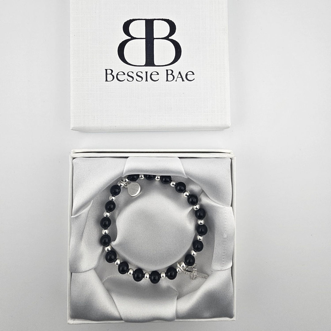 Minimalist Christian jewellery with onyx beads and silver star charm.