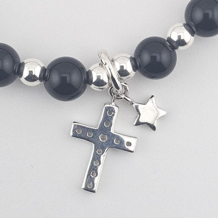 Faith-inspired silver bracelet with polished black gemstones.