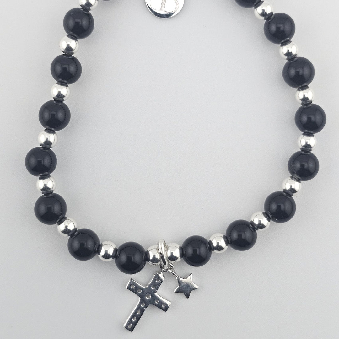 Elegant black onyx beaded bracelet featuring sterling silver cross and star pendants.