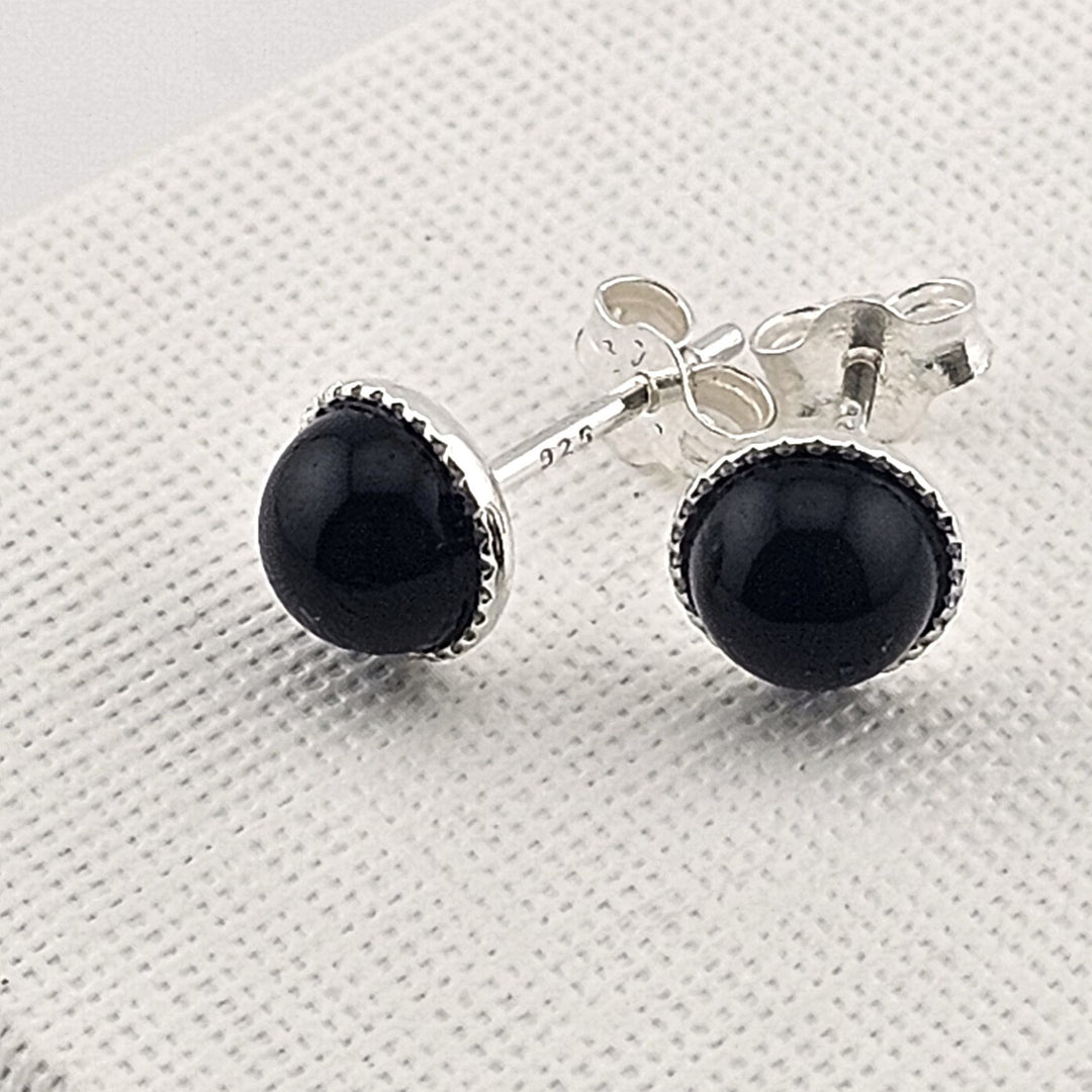 Sterling silver black onyx stud earrings with round gemstone.