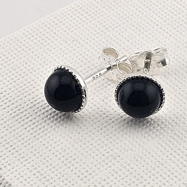 Sterling silver black onyx stud earrings with round gemstone.