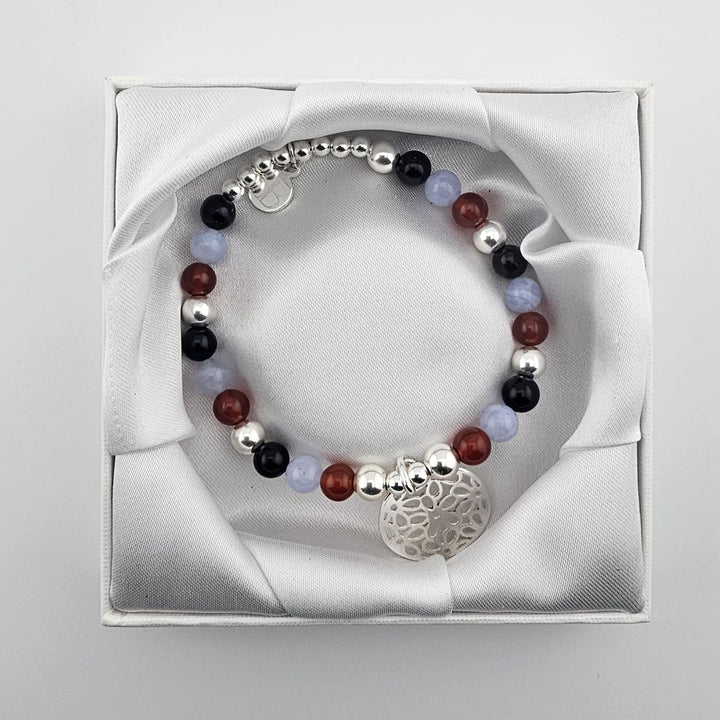 Handmade gemstone bracelet with silver open flower charm.