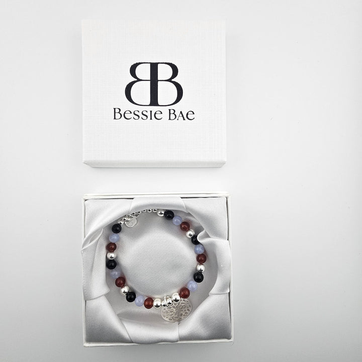 Bohemian gemstone bracelet with sterling silver flower pendant.