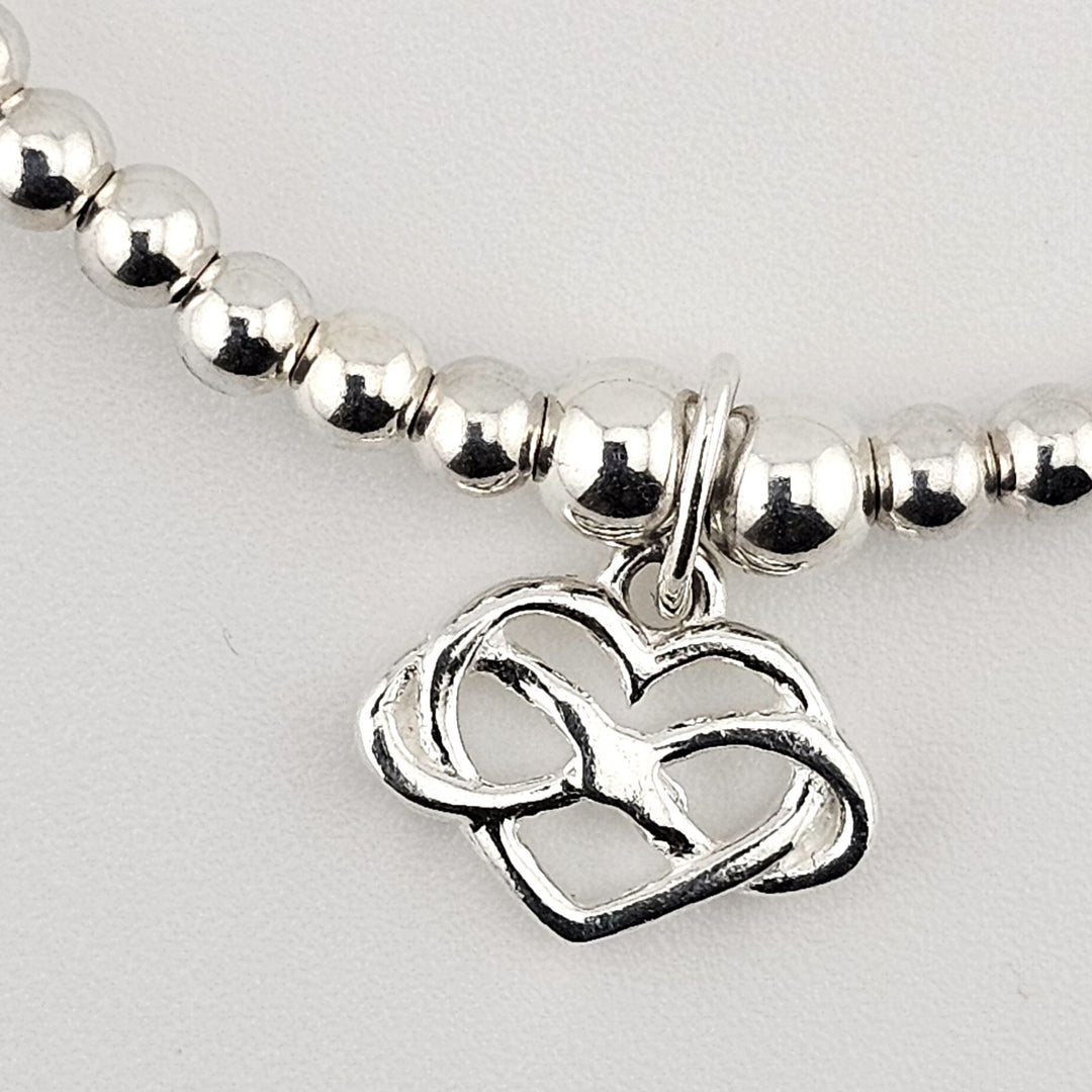 Sterling silver beaded bracelet with infinity heart charm – elegant symbolic jewellery gift.