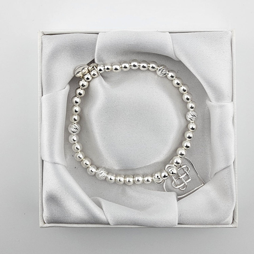 Top view of Celtic heart silver bracelet in satin box.