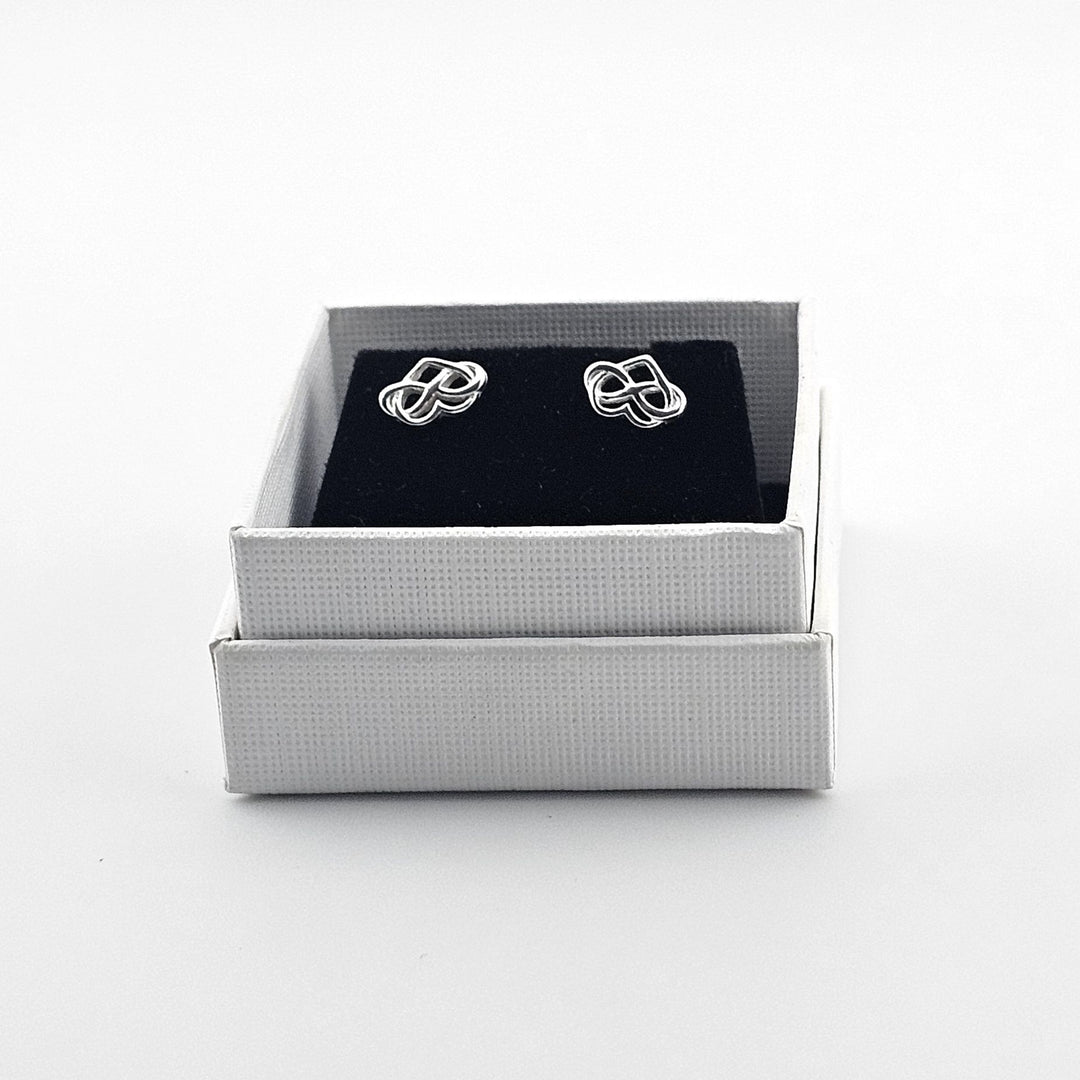 Dainty silver heart earrings with scroll fittings.