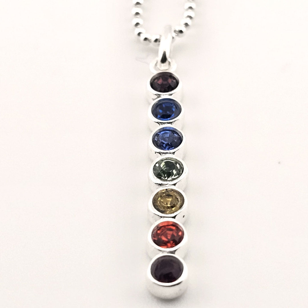 Sterling silver chakra necklace with seven gemstones in vertical design.