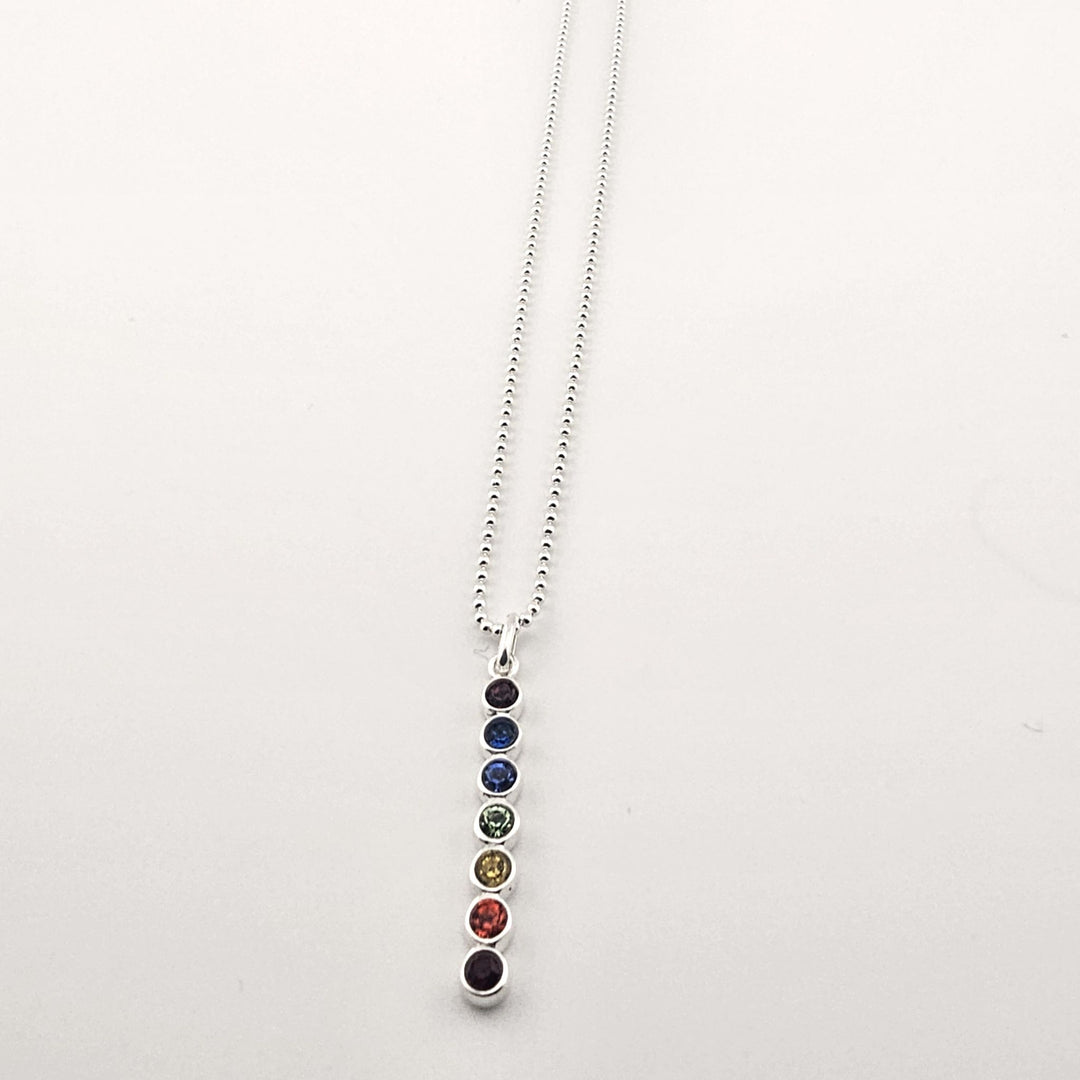 Seven stone healing pendant symbolising energy balance and chakras.