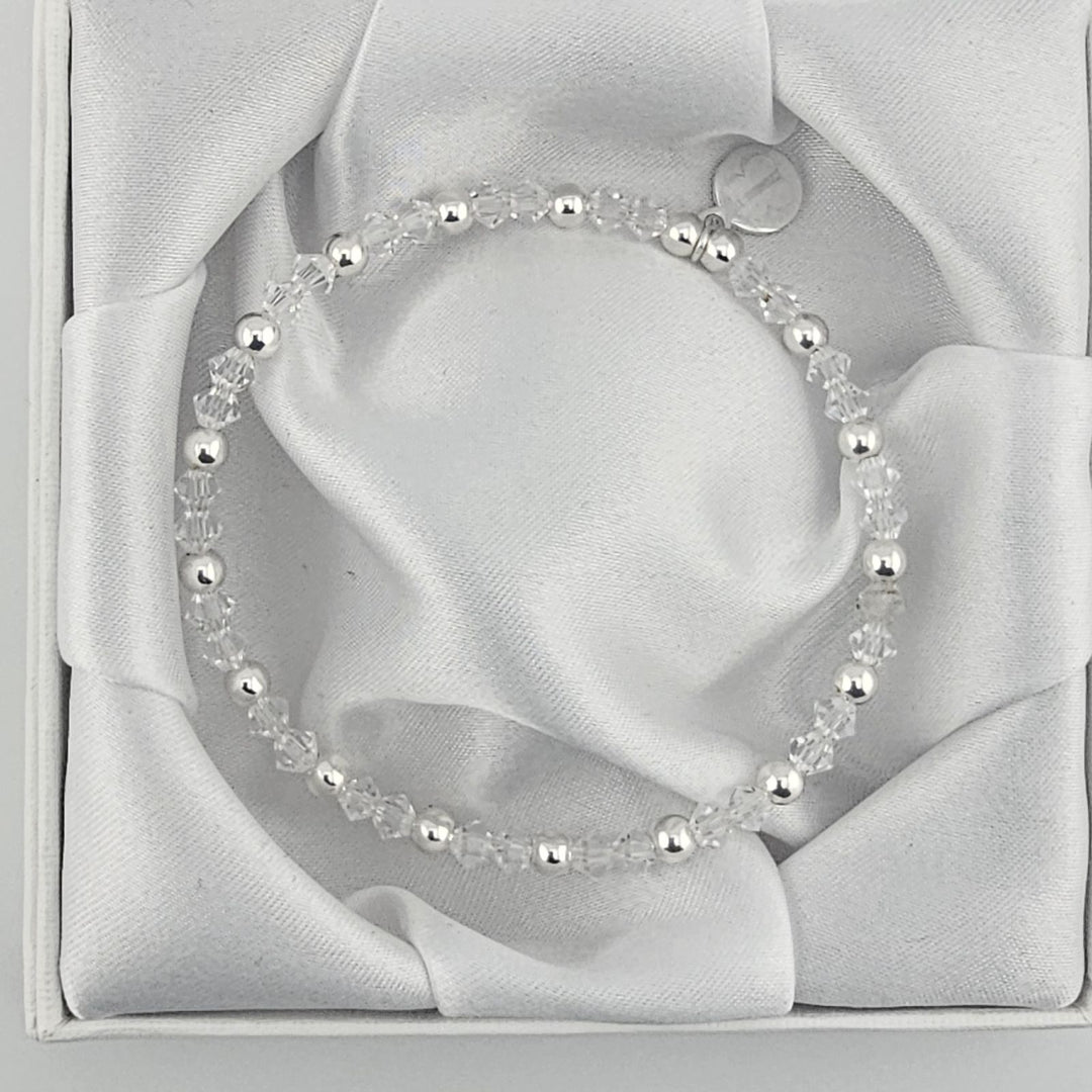 Minimalist silver bracelet featuring faceted crystal beads.