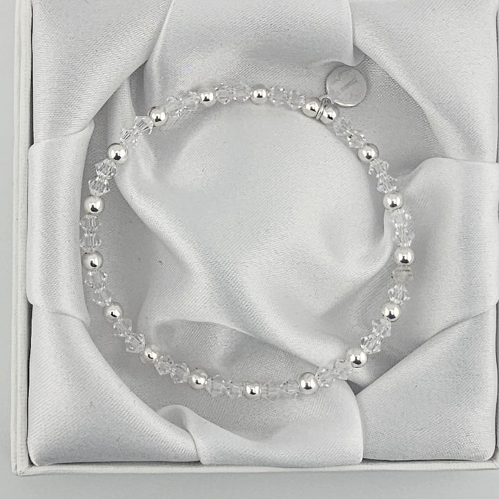 Minimalist silver bracelet featuring faceted crystal beads.