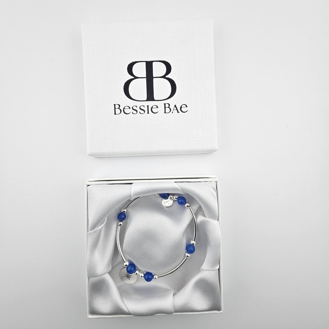 Handmade 925 silver compass bracelet featuring blue onyx beads.