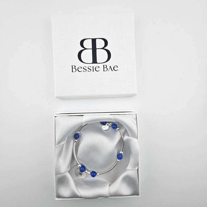 Handmade 925 silver compass bracelet featuring blue onyx beads.