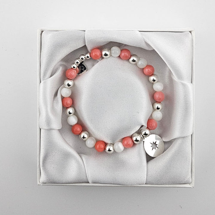 Handcrafted sterling silver and mother of pearl bracelet in satin gift box.