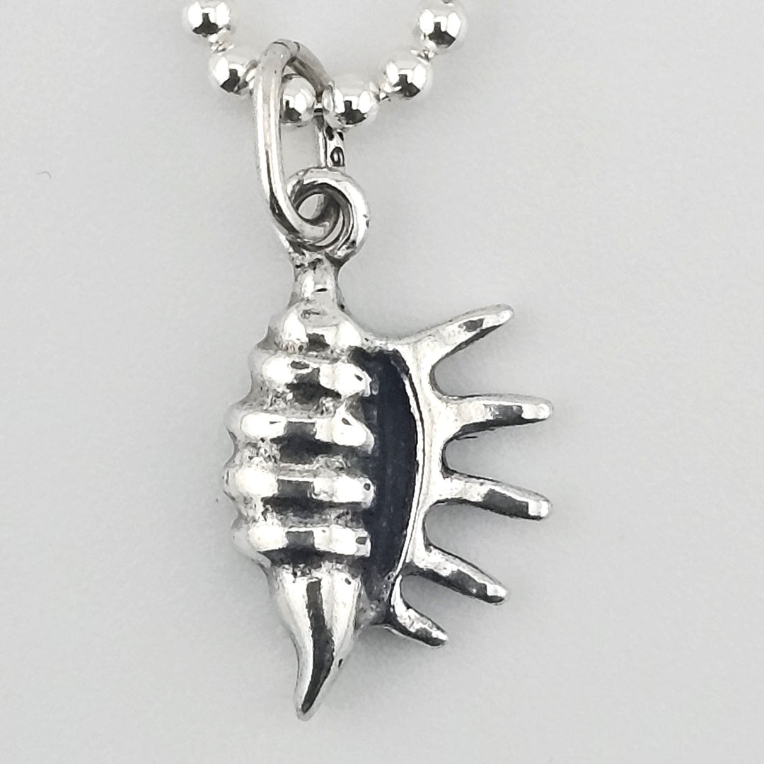 Close-up of 925 sterling silver conch shell charm with textured detail.