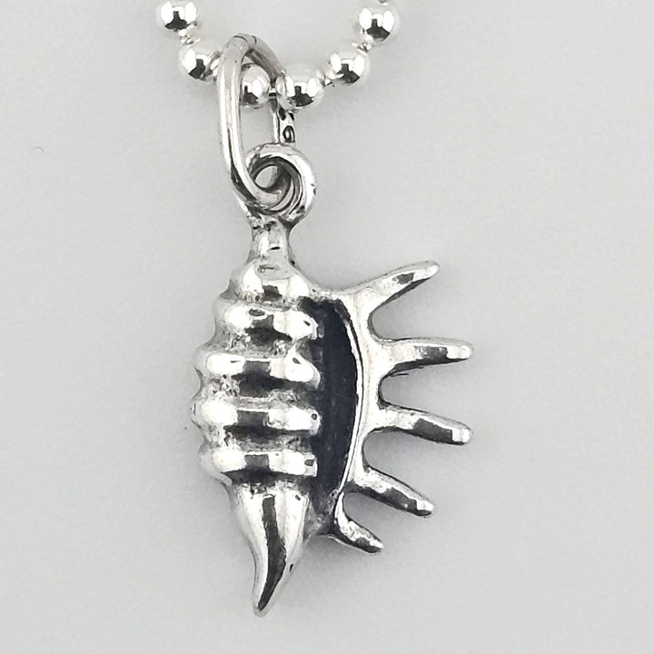 Close-up of 925 sterling silver conch shell charm with textured detail.