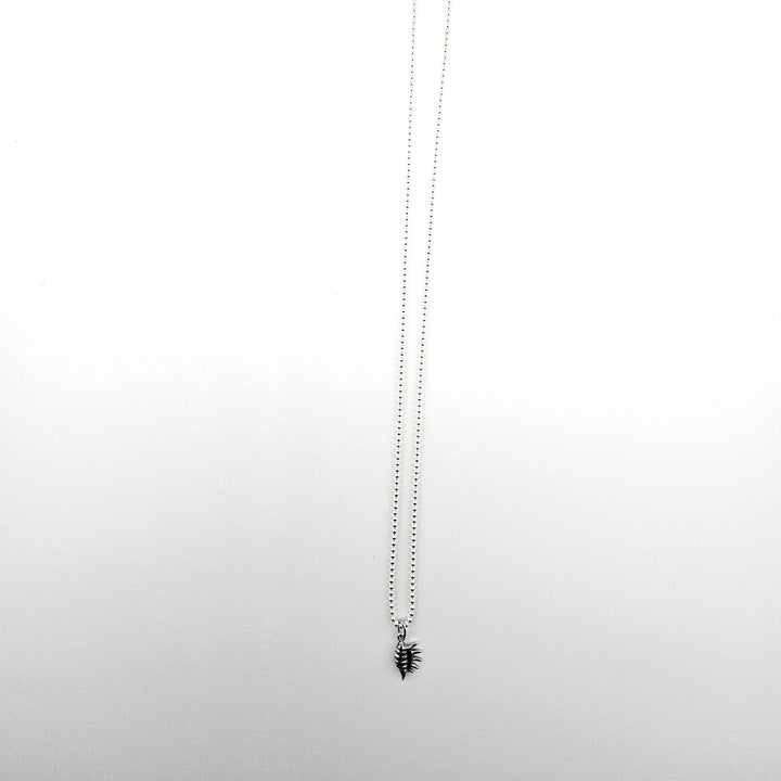 Sterling silver conch shell charm necklace on 18 inch ball chain.