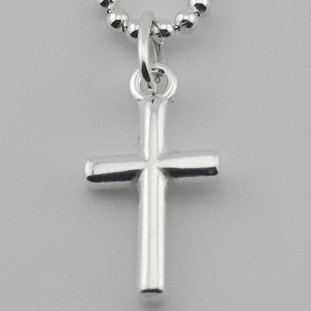 Unisex sterling silver cross pendant with fine link chain.