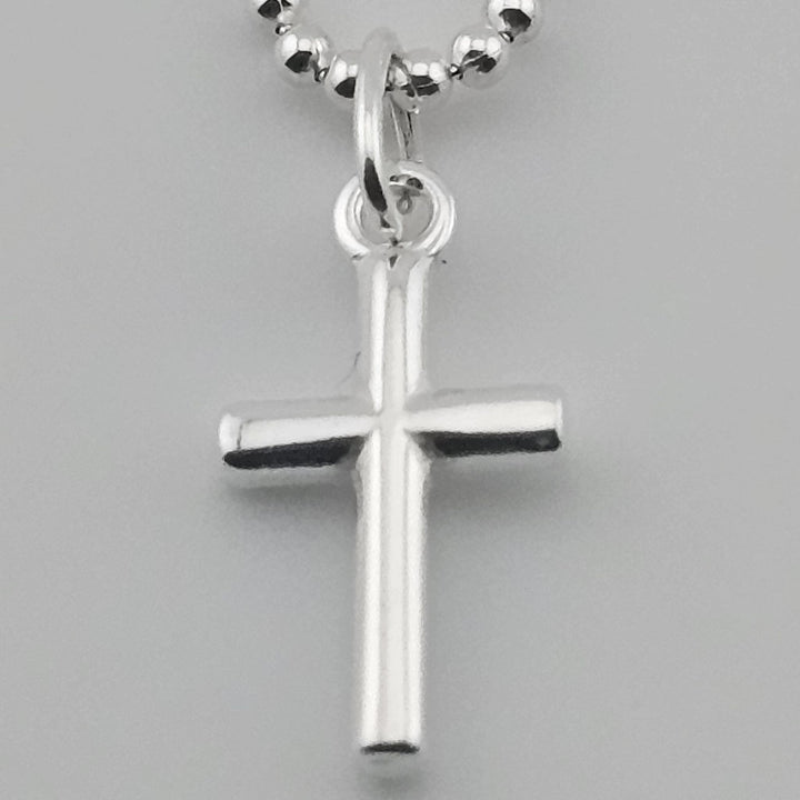 Unisex sterling silver cross pendant with fine link chain.
