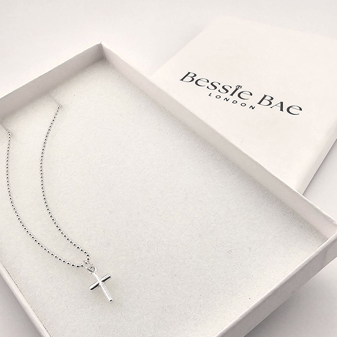 Sterling silver cross necklace with polished pendant on fine chain in box