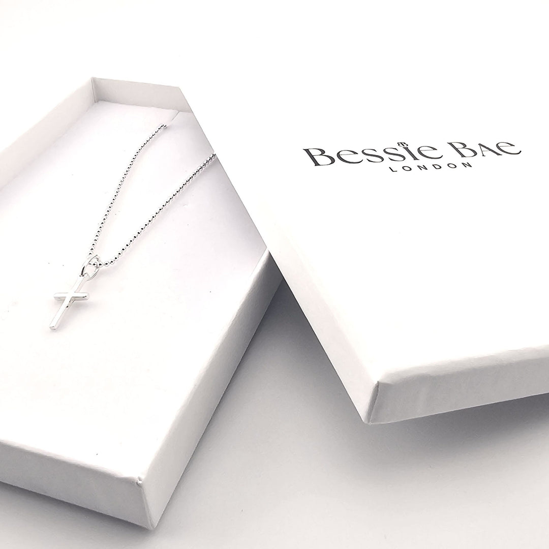 Minimalist sterling silver cross necklace, timeless Christian symbol jewellery.