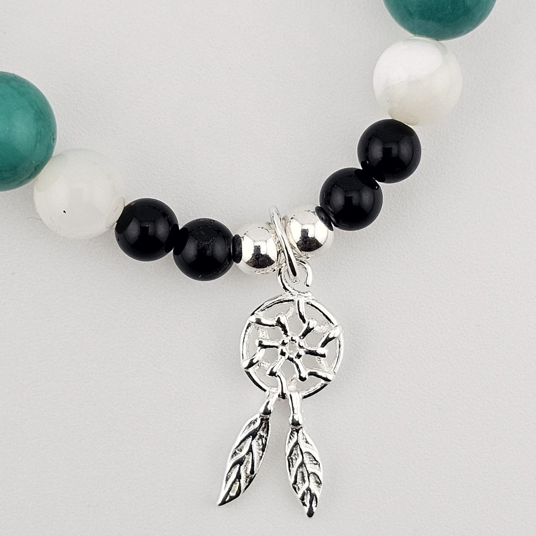 Sterling silver and gemstone bracelet featuring turquoise and onyx beads.