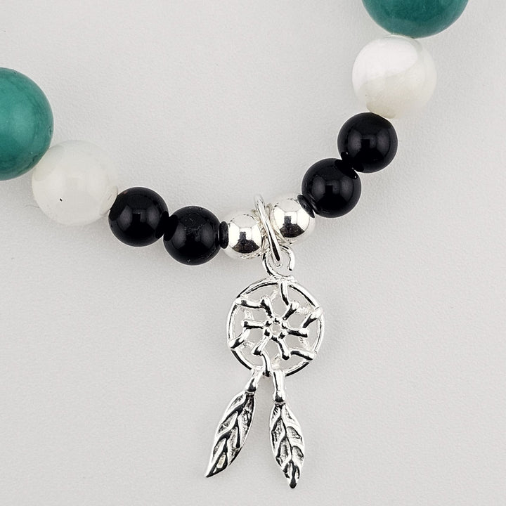 Sterling silver and gemstone bracelet featuring turquoise and onyx beads.