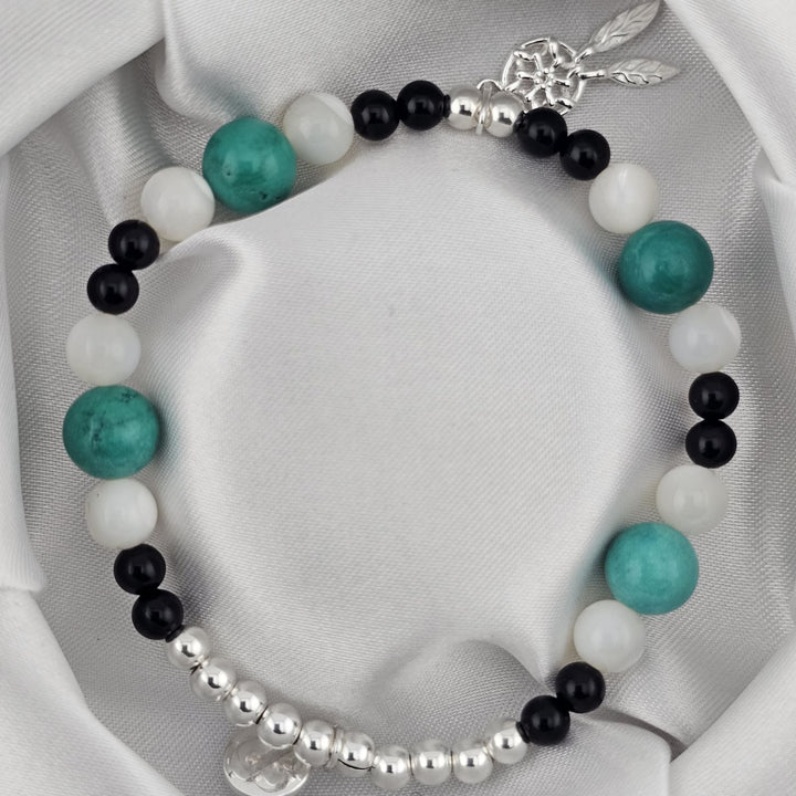 Handmade beaded bracelet with dreamcatcher charm in sterling silver.