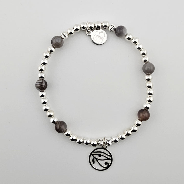 Sterling silver Eye of Horus bracelet with Botswana agate gemstones.