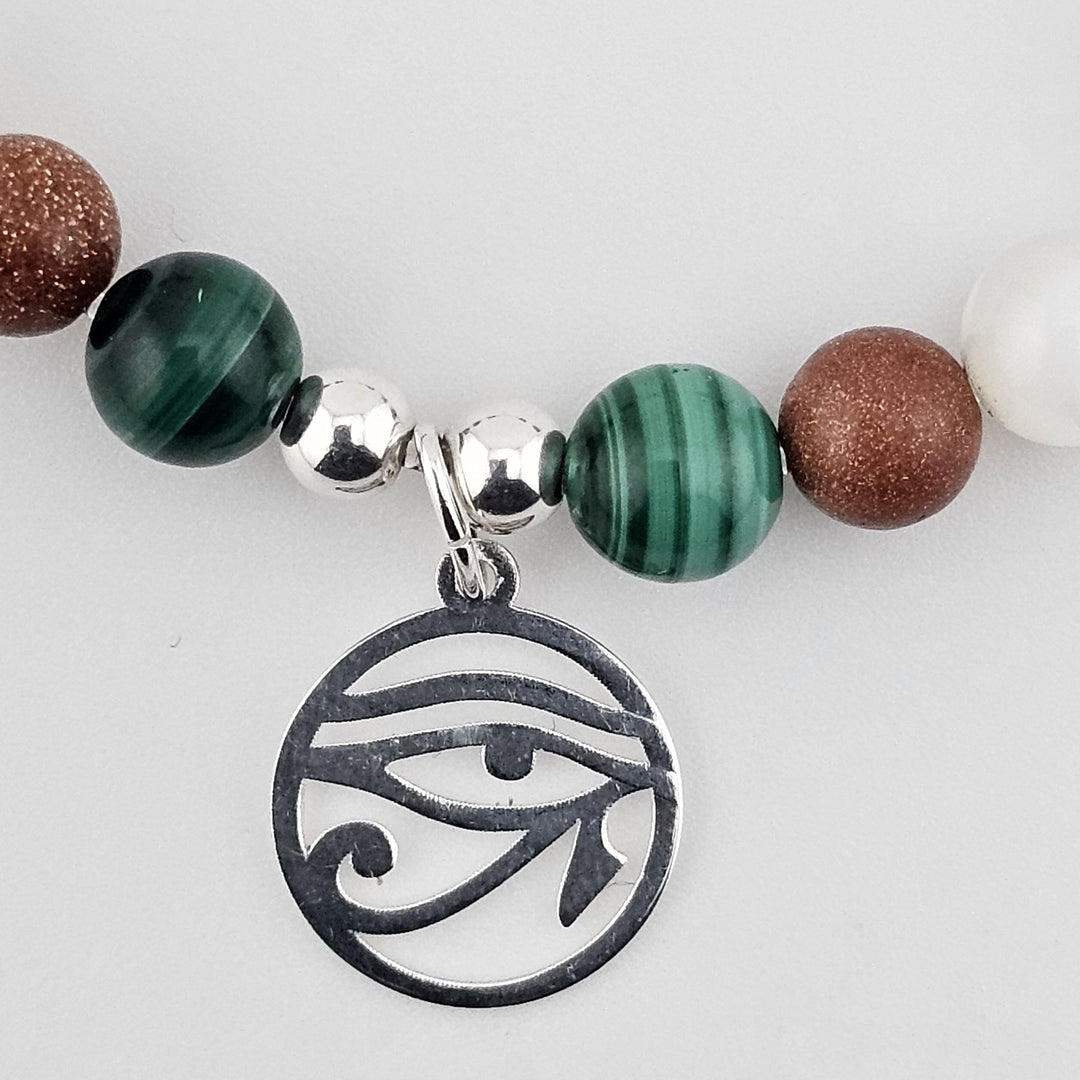 Bohemian gemstone bracelet featuring Eye of Horus charm and natural stones.
