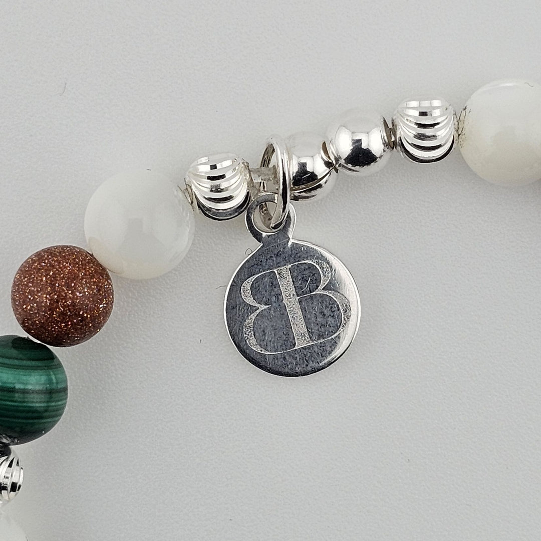 Handmade silver and gemstone bracelet symbolising wisdom and protection.
