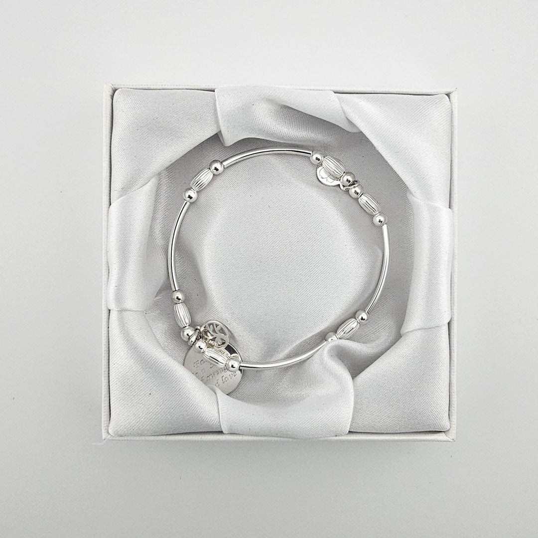 Silver beaded bracelet with engraved family message charm.