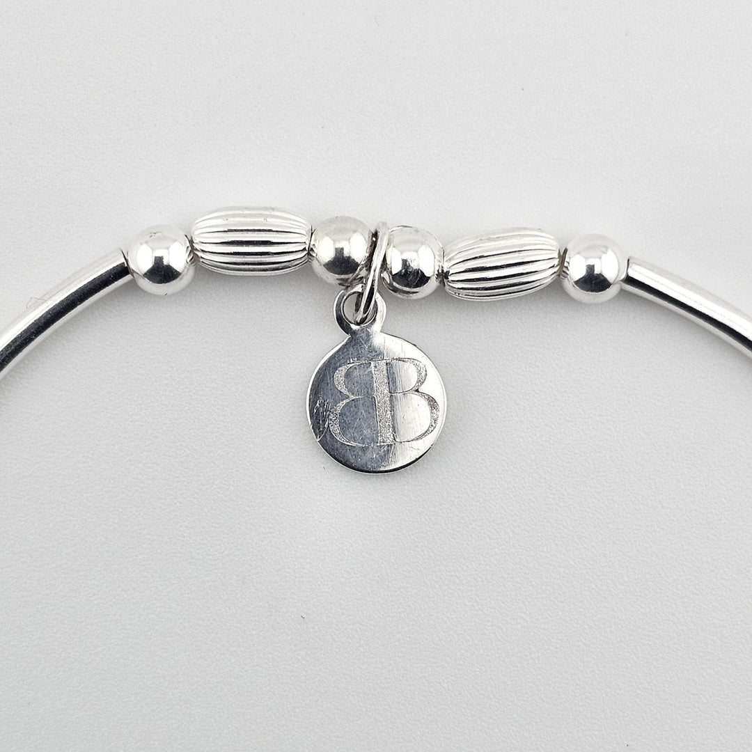 Elegant silver bracelet symbolising love and unity.