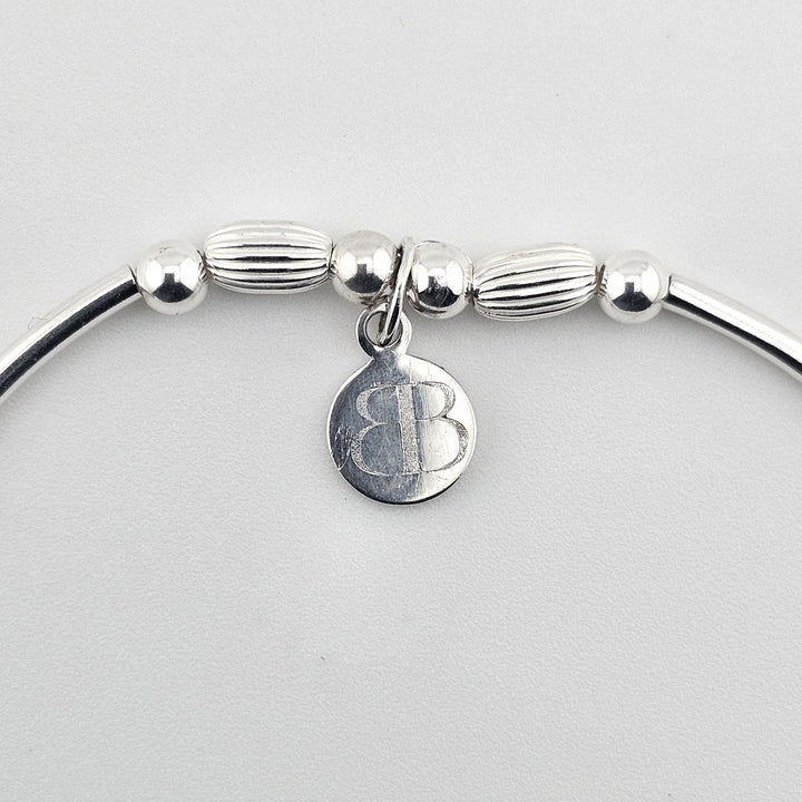 Elegant silver bracelet symbolising love and unity.