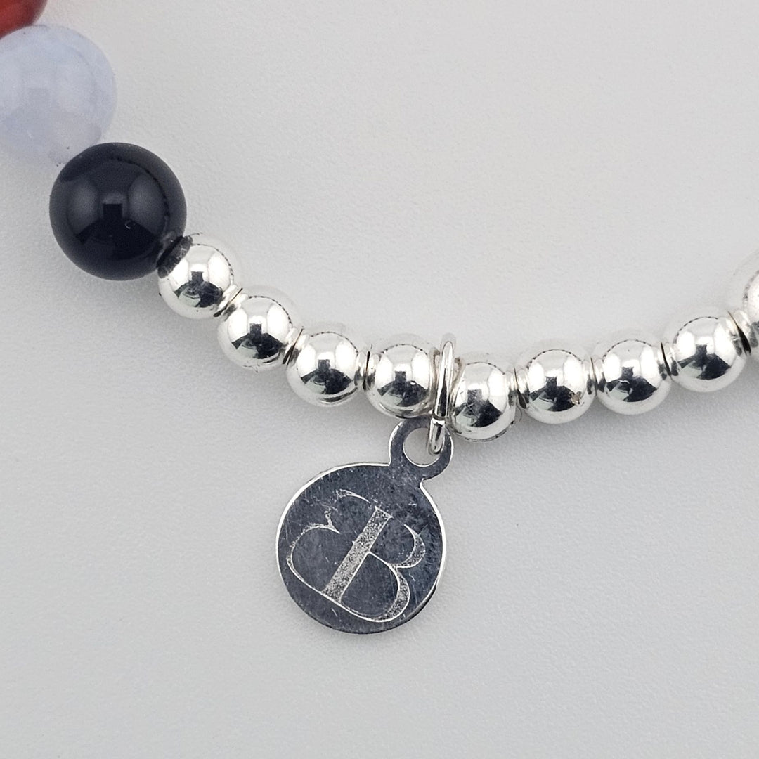 Elegant silver bracelet with blue lace agate and garnet stones.