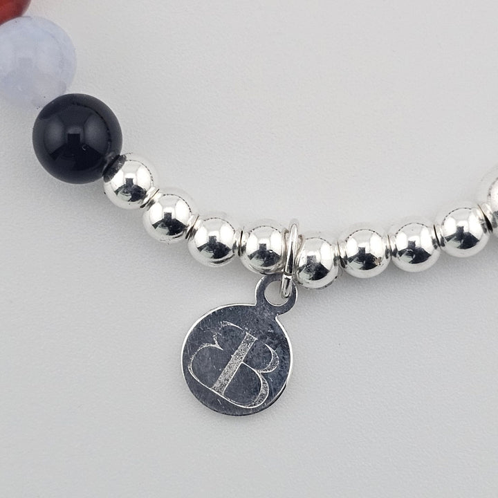 Elegant silver bracelet with blue lace agate and garnet stones.