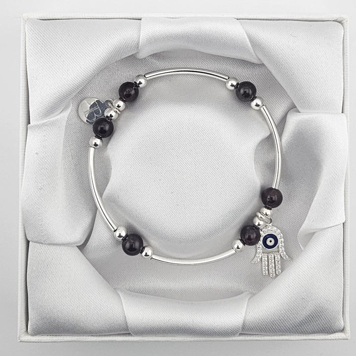 Garnet gemstone bracelet featuring Hamsa Hand and evil eye design.
