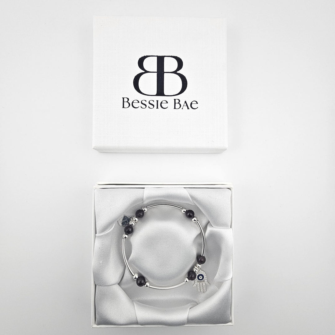 Sterling silver beaded bracelet with deep red garnet gemstones.