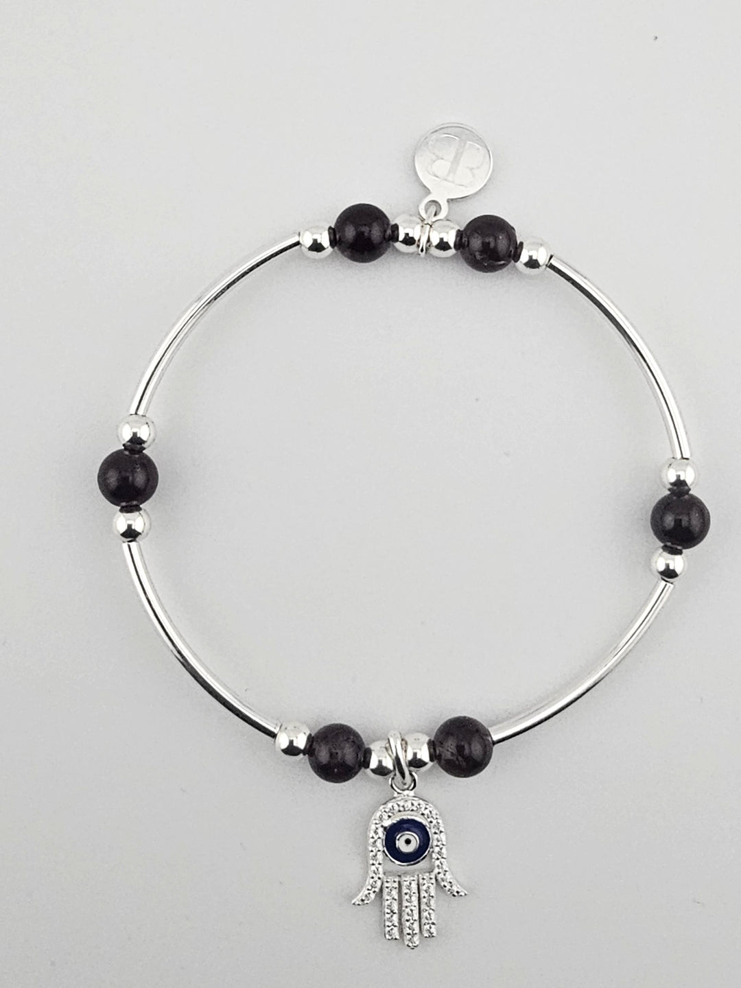 Sterling silver bracelet with garnet beads and Hamsa Hand charm.