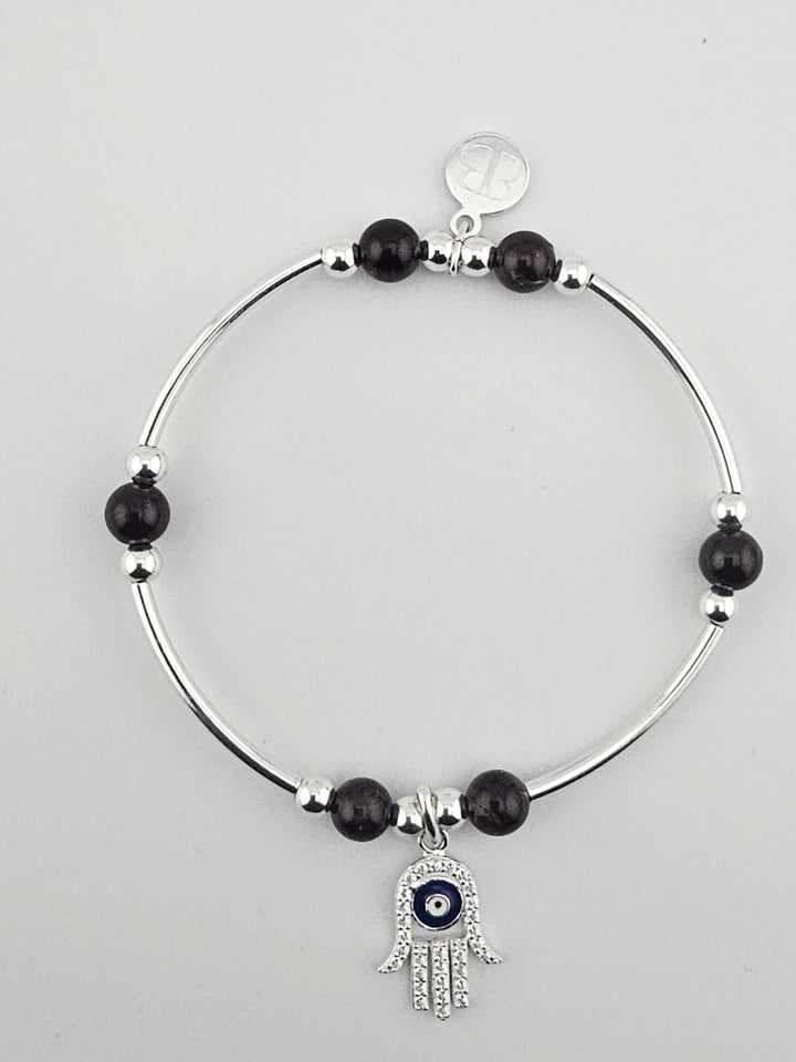 Sterling silver bracelet with garnet beads and Hamsa Hand charm.