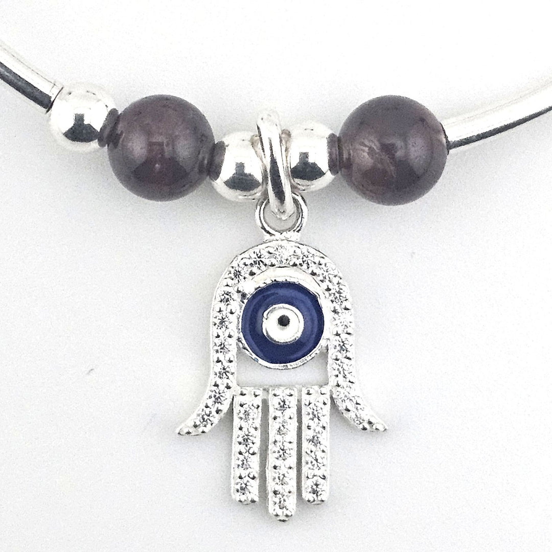 Handmade sterling silver protection bracelet with garnet stones.