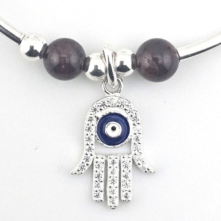 Handmade sterling silver protection bracelet with garnet stones.